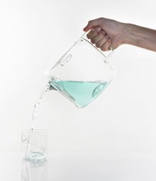 Designer Antonio Aric&ograve; set out to design a simple glass water carafe with a rounded, block-like design that had a handle, as a way to offer guests a fresh glass of water