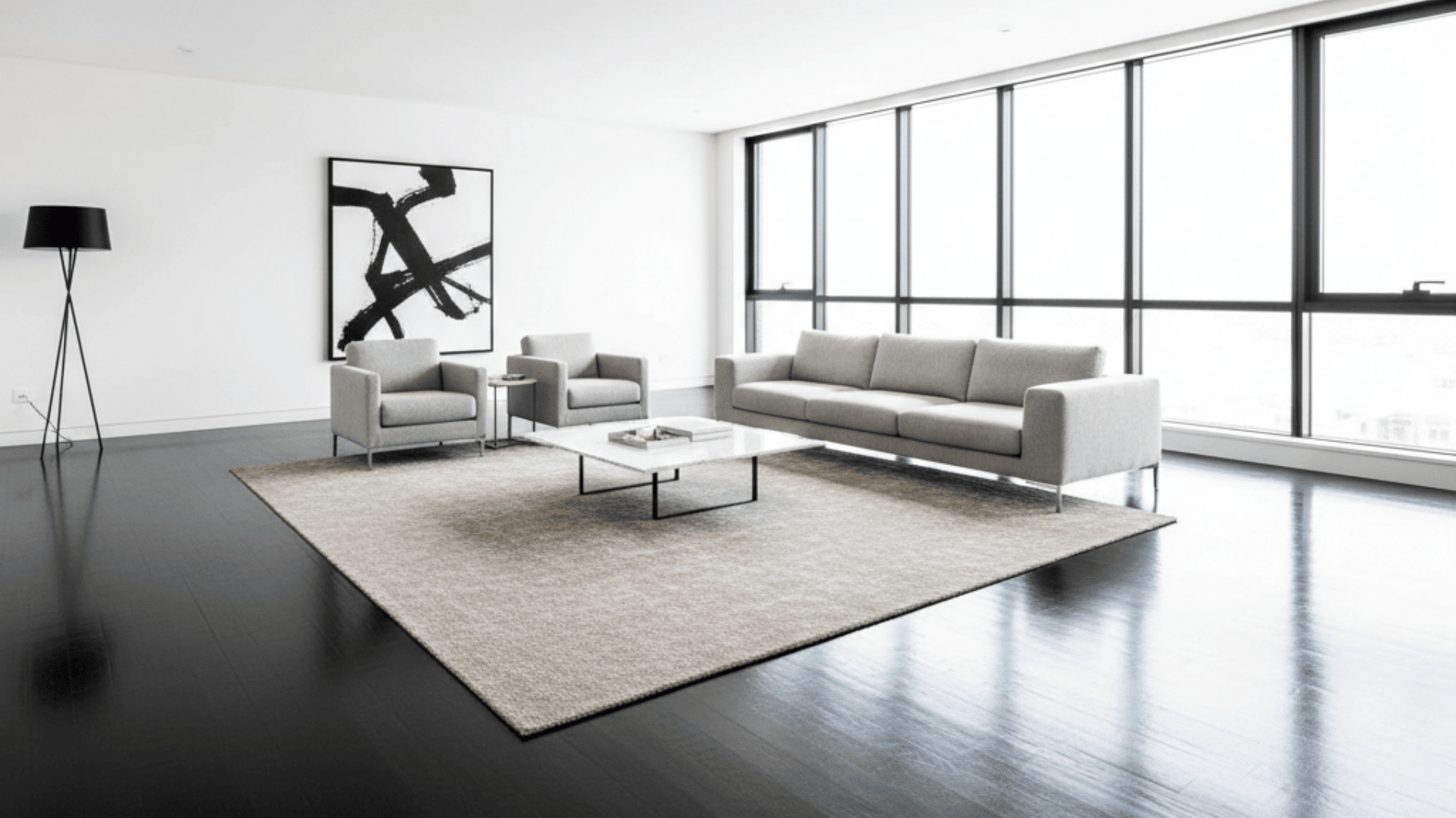 A modern living room featuring ebony hardwood floors and sleek white furniture against white walls.