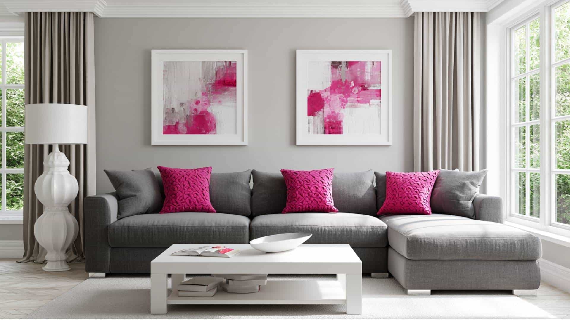Gray living room with hot pink accent cushions, abstract wall art, and modern bright decor.