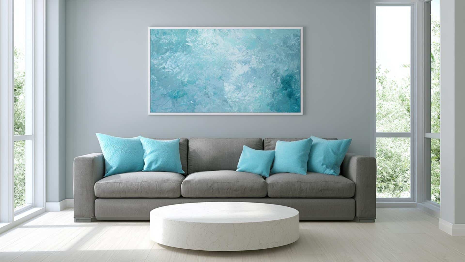Fresh gray living room with ice blue cushions, abstract artwork, and bright modern minimalist styling.