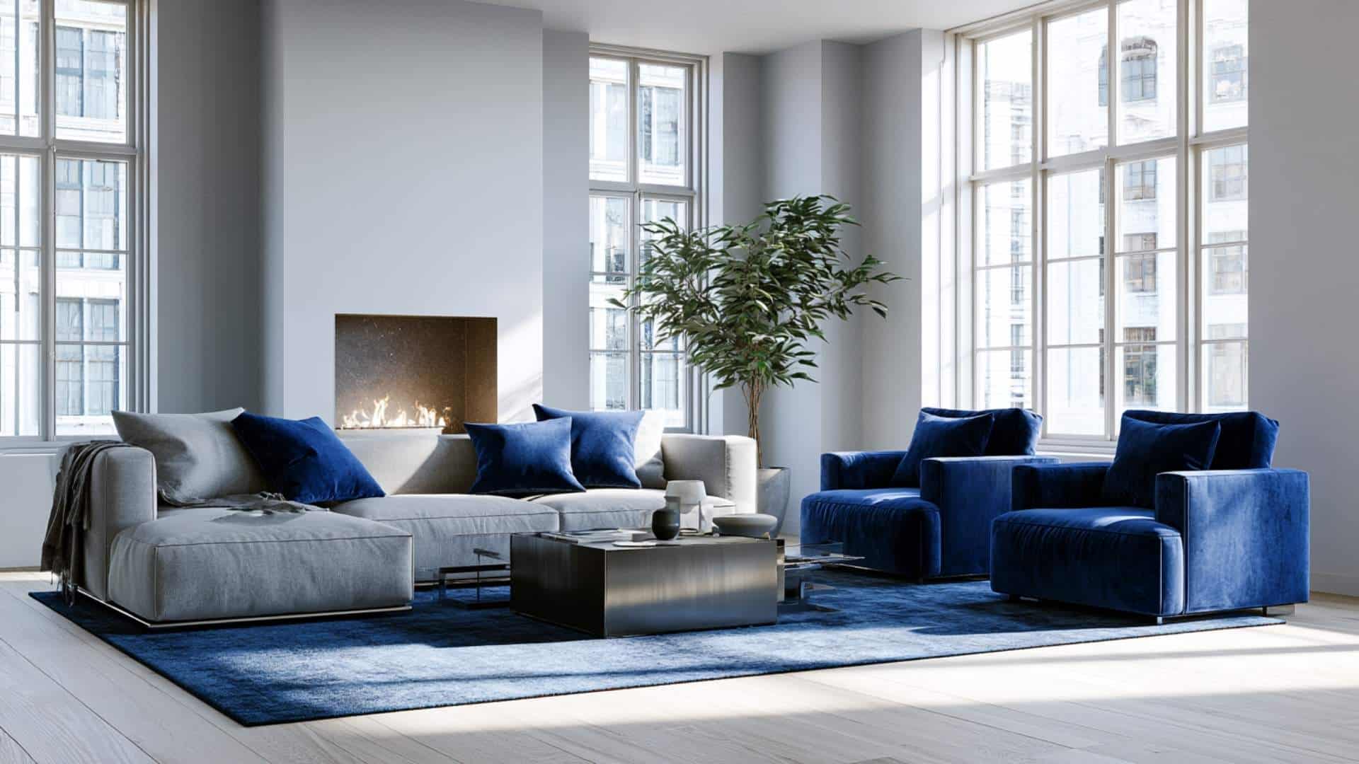 Elegant gray living room with navy blue velvet seating, fireplace, and refined contemporary styling.