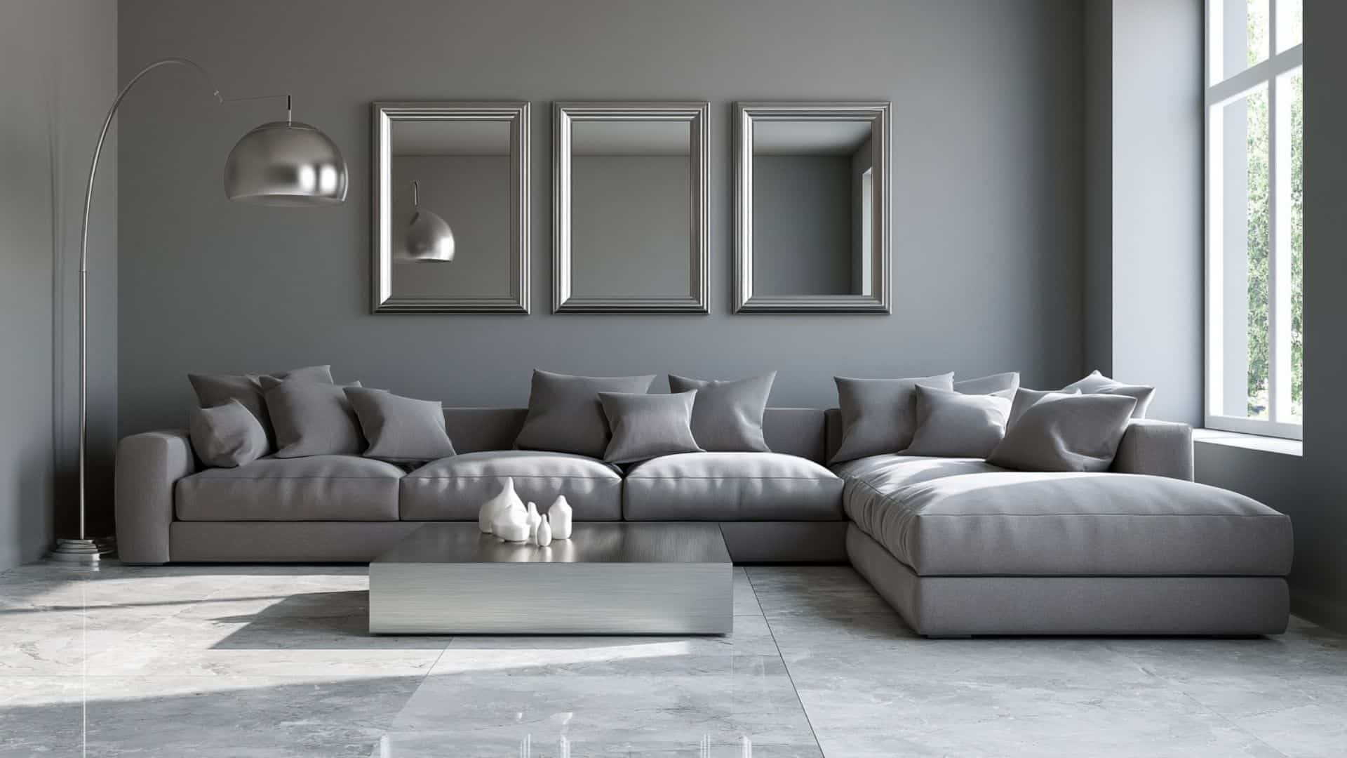 Minimal gray living room with silver accents, modular sofa, mirrors, and clean contemporary styling.