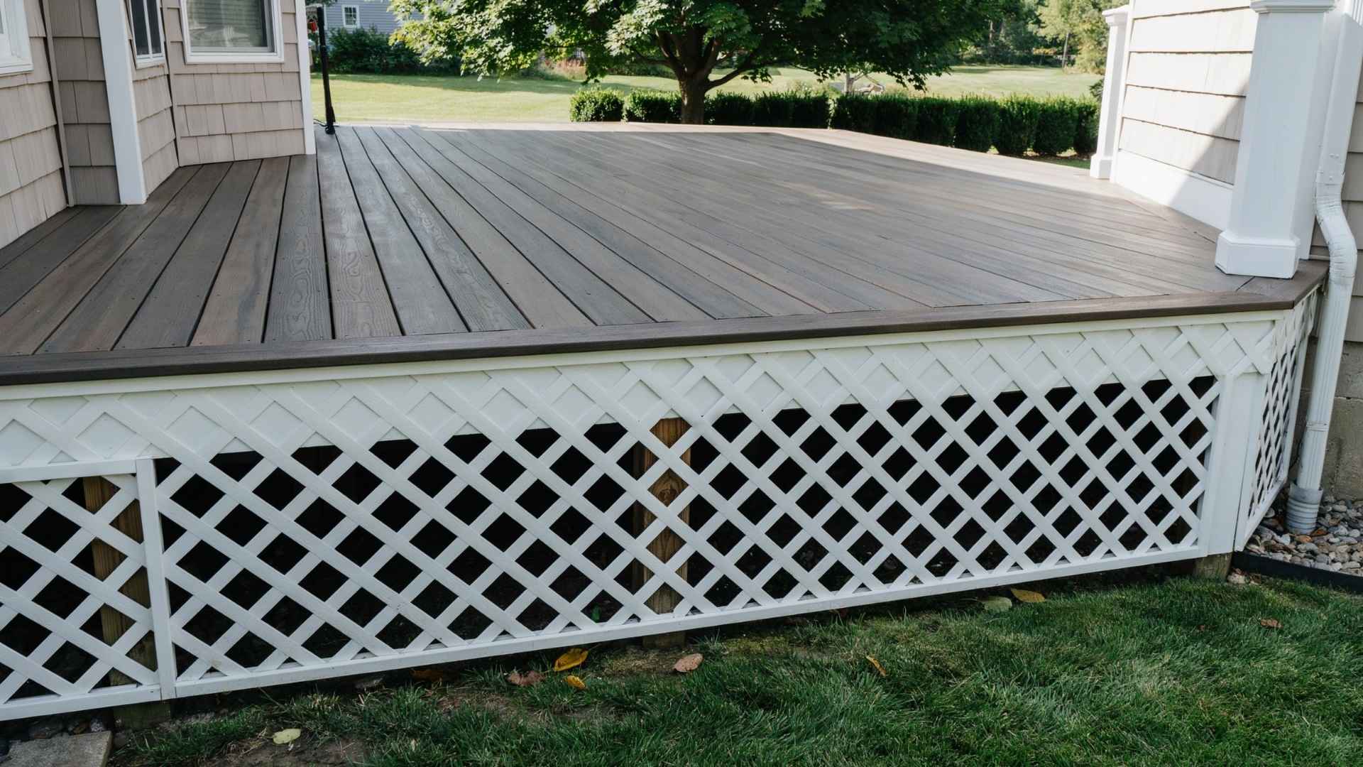 Custom-painted white lattice pattern skirting below a wood deck.
