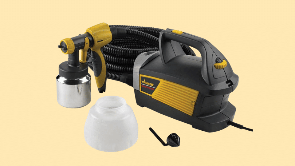 Wagner Control Spray Max HVLP paint sprayer with spray gun, hose, and detachable paint containers on a light background.